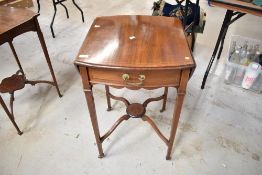 An Edwardian Mahogany oval drop leaf Pembroke table having under drawer and inlaid banding