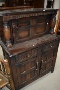 A 20th century dark oak sideboard having under and over cupboard with two drawers