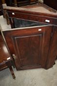 A Victorian corner cupboard with mahogany case
