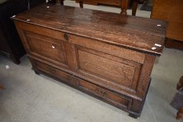 A period oak kist having panelled front and drawer to base