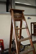 A traditional set of wooden step ladders, decorators or similar, large 8 rung design