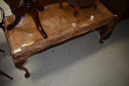 A mid 20th Century walnut coffee table having glass insert