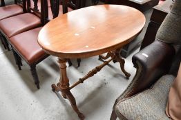 A Victorian oval centre table with carved and turned supports possibly with new top or having been