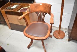 A 20th century Captains chair with beech wood frame and leather seat
