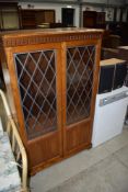 A Priory style display cabinet , in mid colour golden oak, nice condition and quality