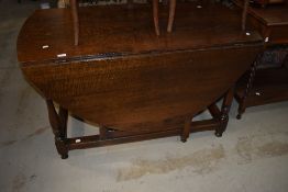 A period style heavy oak gateleg dining table