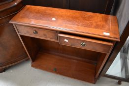 A reproduction Regency hall small bookshelf with double drawer