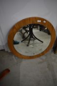 A vintage wood laminate circular wall mirror