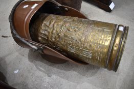 A copper coal helmet and a brass stick stand