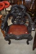 An Oriental carved throne style chair