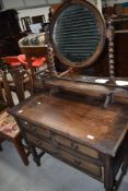 An early 20th Century oak dressing table having twist legs
