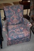 A traditional easy chair having Morris style upholstery