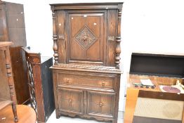 A modern oak court cupboard with drawer and cupboard storage