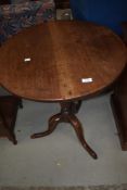 A Victorian mahogany and oak pedestal table having circular snap top on turned column and triple