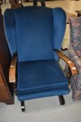 A vintage stained frame rocker having blue dralon upholstery