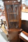 A reproduction Regency corner display with cupboard under