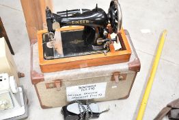 An early 20th century electric Singer Sewing machine with case