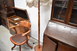 A mid century turned teak standard lamp