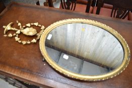 A regency oval framed mirror with gilt and gesso design with floral decoration