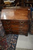 A 19th Century mahogany bureau of nice proportions having four long drawers with brass drop