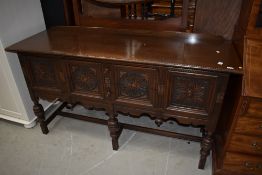 A reproduction oak dresser base in the Priory style