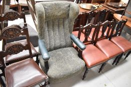 A modern easy arm chair with high wing back