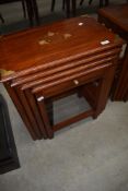 A nest of four Eastern style occasional tables with brass detailing