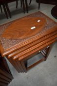 A nest of four Eastern style occasional tables with brass detailing