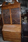 A 19th Century mahogany bureau bookcase having inlay decoration, astral glazed doors to bookcase