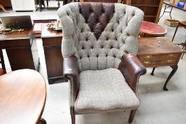 A modern wing back arm chair having Harris Tweed and button back leather upholstery