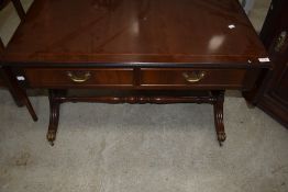 A reproduction coffee table having lions paw feet and double drawer set
