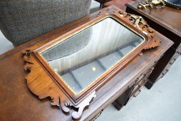 A late Victorian hall mirror having carved fret work frame with gilt decoration and ho ho bird