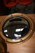 A vintage convex wall mirror