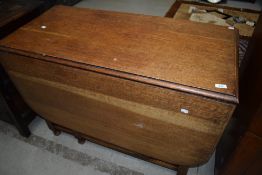 A traditional oak twist gate leg dining table