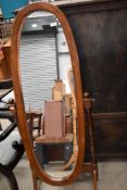 A modern stained frame cheval mirror