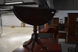 A reproduction Regency mahogany occasional table having drop flaps