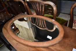 An early 20th Century stripped frame oval wall mirror