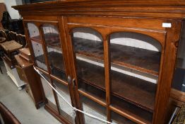 A 19th Century stained frame library bookcase having panelled back