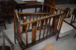 A vintage wooden child's cot, sold as decorative