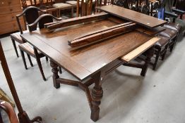 A modern dark oak extending dining table with turned legs
