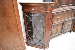 A Victorian corner cupboard with Astral glazed door and inlaid veneer details
