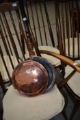 A traditional copper bed warmer or chestnut roaster