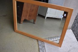A modern beech effect wall mirror, approx 75 x 54cm