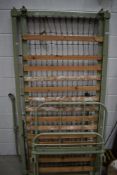 Two vintage metal single bed frames, possibly hospital or prison related