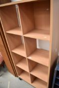 A laminate shelf unit/room divider with castors