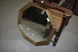 A gilt frame octagonal wall mirror