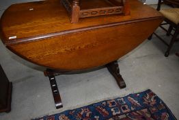 A Priory style drop leaf dining table