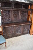 A 19th Century oak tridarn style sideboard in the Jacobean style with heavily carved panels and