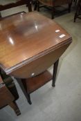 An Edwardian mahogany occasional table having drop flaps