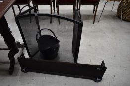 A Victorian cast fire fender, modern coal helmet and guard